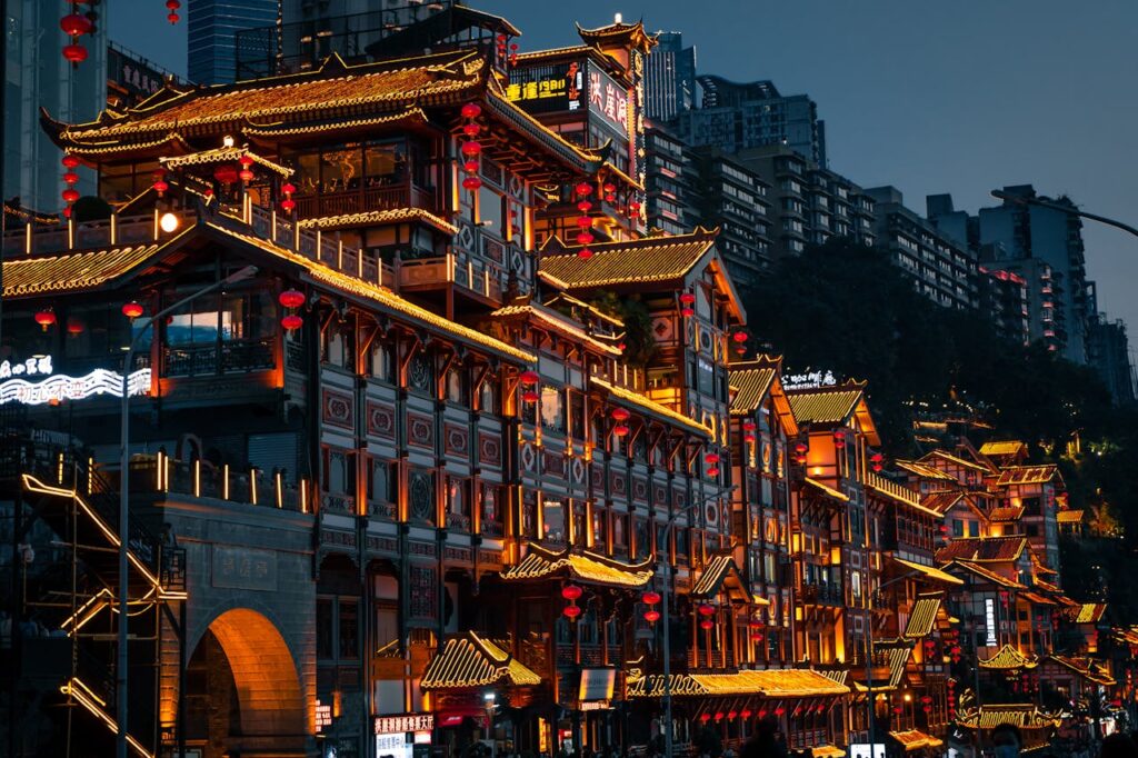 A city street with many buildings lit up at night